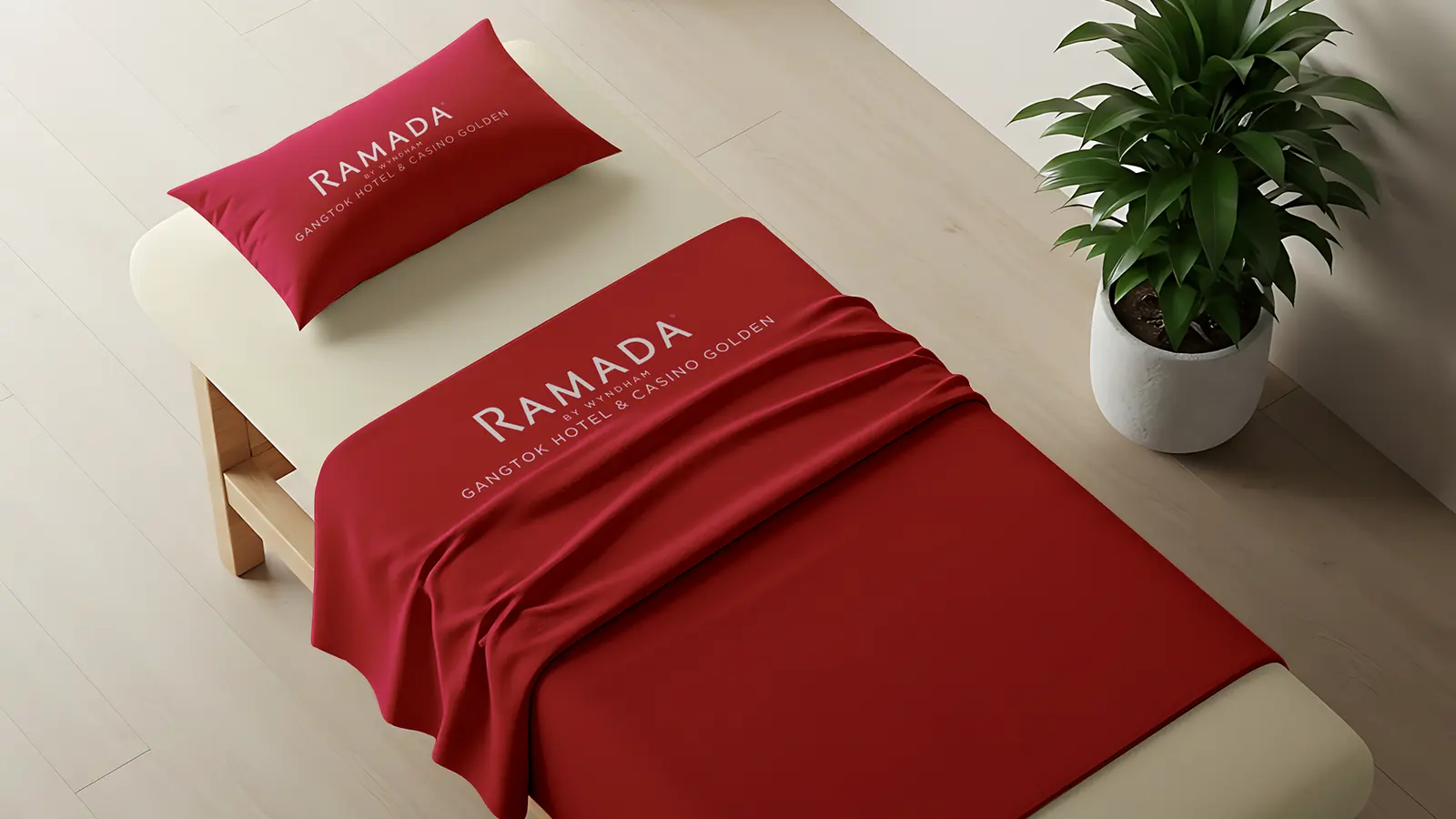 Ramada Gangtok brand identity: red pillow and bed runner carrying the hotel logo