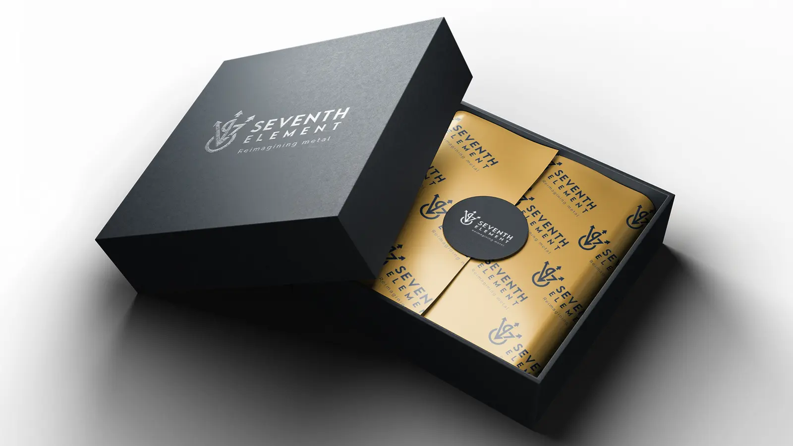Seventh Element brand identity: black gift box with gold branded wrapping